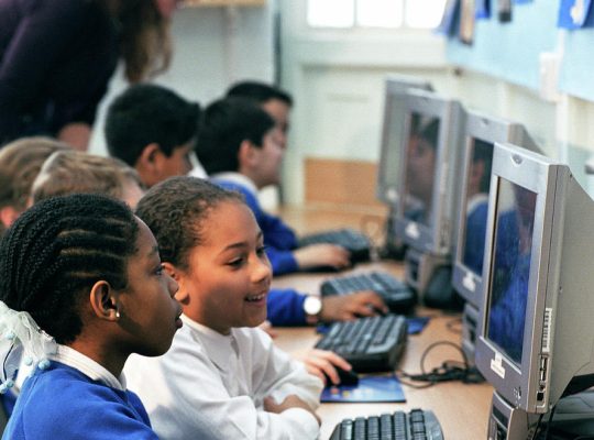 1-schoolchildren-using-computers-martin-riedlscience-photo-library
